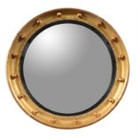 A giltwood and composition convex wall mirror in Regency style