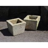 A pair of rough-hewn stone planters