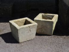 A pair of rough-hewn stone planters