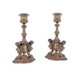 A pair of gilt bronze Egyptian Revival candlesticks