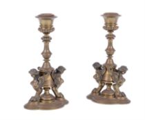 A pair of gilt bronze Egyptian Revival candlesticks