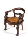 A carved and stained oak desk chair