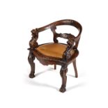 A carved and stained oak desk chair
