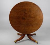 A George IV circular oak dining table