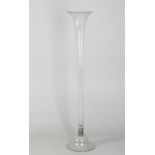 A tall glass floral arrangement vase