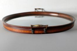 An early 20th Century mahogany and glass twin handled circular tray