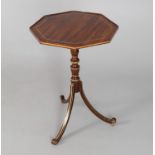 A parcel gilt and simulated rosewood octagonal tripod occasional table