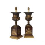 A pair of Empire patinated and parcel gilt bronze and rouge griotte mounted campana urns