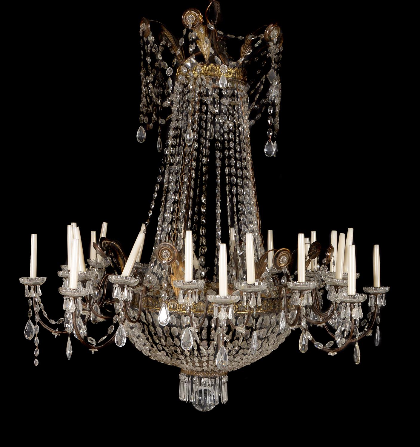 A pair of Continental clear glass and gilt metal mounted twenty-four light chandeliers in early 19th