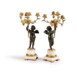 A pair of French gilt bronze and white marble mounted figural four light candelabra