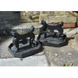 A pair of Regency black painted cast iron boot scrapes