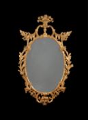 A George III oval wall mirror, circa 1770, in the manner of Thomas Chippendale