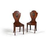 A pair of George III mahogany hall chairs