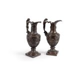 A pair of patinated bronze ewers in the manner of Nicholas Delaunay
