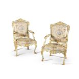 A pair of Italian carved wood, painted and parcel gilt armchairs, mid 18th century