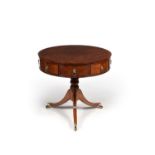 A Regency mahogany and 'plum pudding' mahogany drum library or 'rent' table