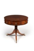 A Regency mahogany and 'plum pudding' mahogany drum library or 'rent' table