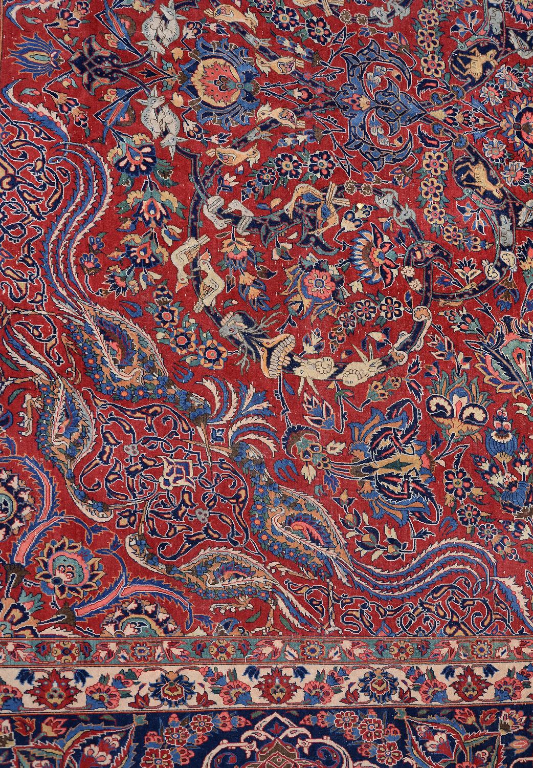 A Kashan carpet, the red field decorated with an overall design
