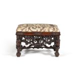 A carved walnut stool, in late 17th century style, in the manner of designs by Daniel Marot