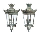 A pair of French verdigris patinated copper and glazed hanging lanterns