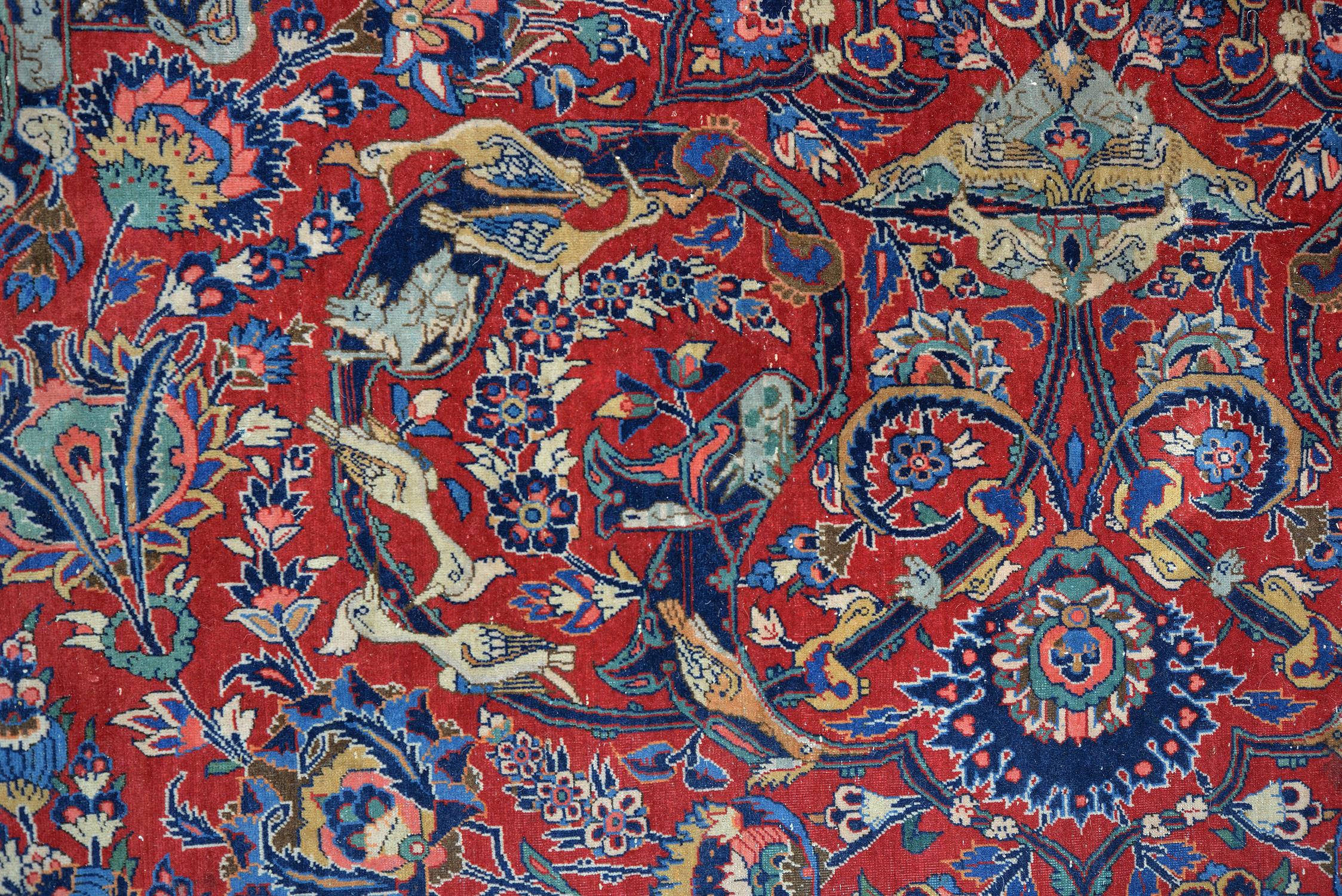 A Kashan carpet, the red field decorated with an overall design