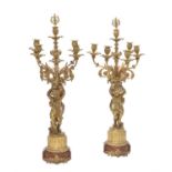 A pair of Napoleon III gilt bronze and stained wood mounted six-light figural candelabra