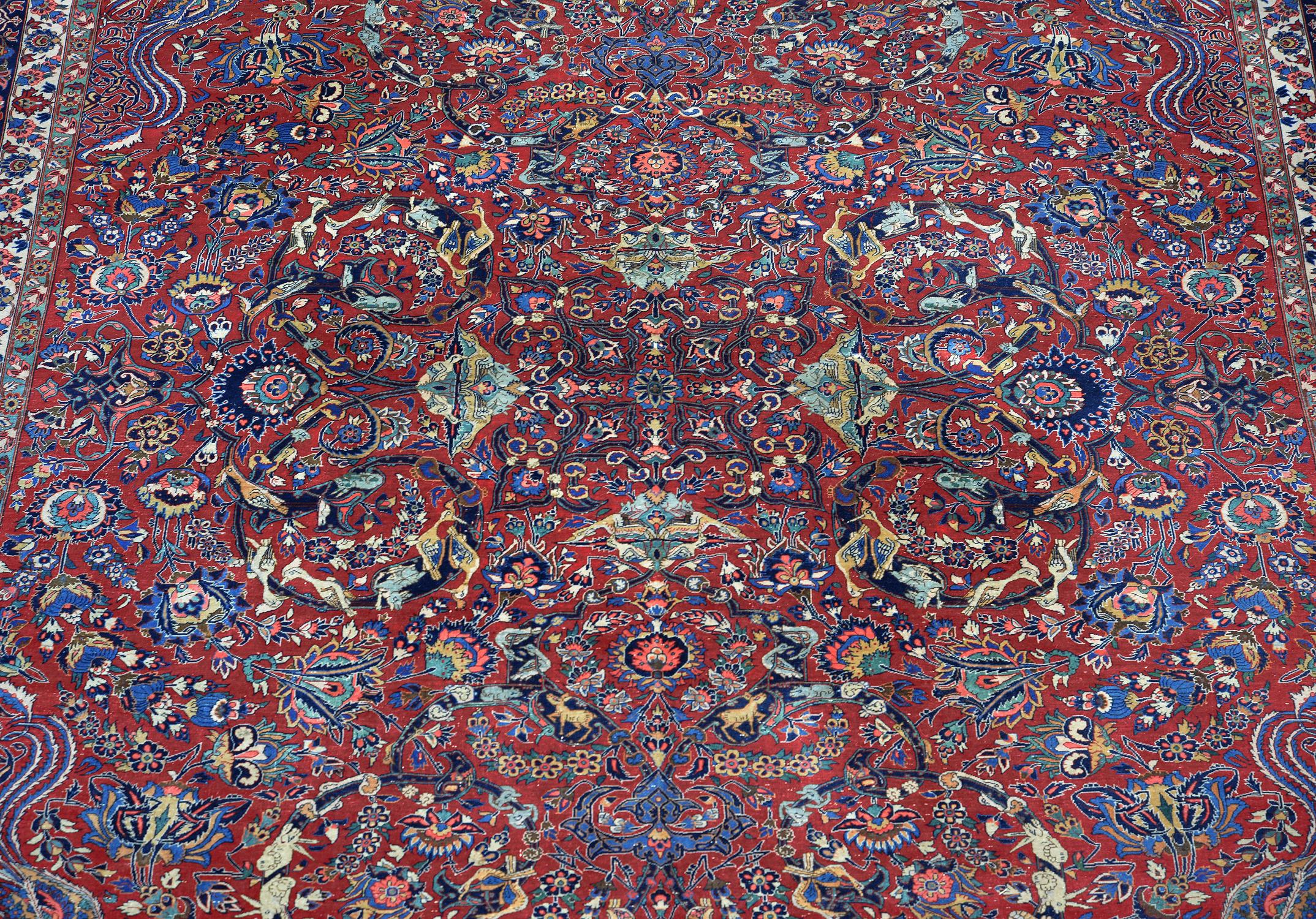 A Kashan carpet, the red field decorated with an overall design