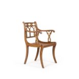 A Regency gothic revival simulated rosewood and parcel gilt armchair