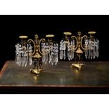 A pair of Regency gilt and patinated bronze twin light lustre candelabra