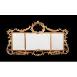 A carved giltwood triptych wall mirror in George III style