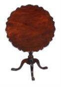 A carved mahogany tilt top occasional table