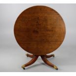 A George IV oak circular dining table
