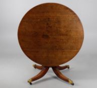 A George IV oak circular dining table