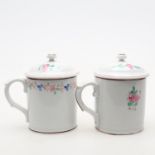 Two near pairs of Russian hand decorated porcelain mugs and covers