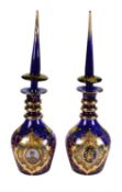 A pair of Turkish blue glass enamelled and gilt large decanters and stoppers printed with portraits