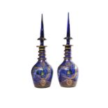 A pair of modern Turkish blue glass, enamelled and gilt large decanters and spire stoppers