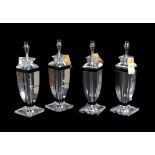 A set of four moulded clear and black glass table lamps