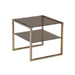 A lacquered brass, polished steel and smoked glass two tier occasional table