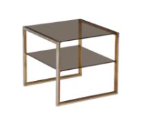 A lacquered brass, polished steel and smoked glass two tier occasional table