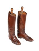 A pair of brown leather riding boots