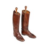 A pair of brown leather riding boots