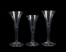 Three plain stemmed wine glasses of drawn trumpet form