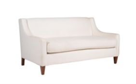 A cream upholstered two seater sofa