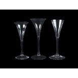 Three plain stemmed toasting glasses of drum trumpet form