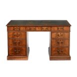 A mahogany and leather inset pedestal desk in George III style