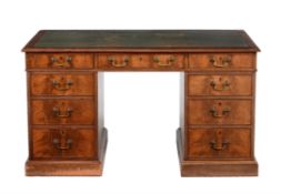 A mahogany and leather inset pedestal desk in George III style