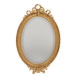 A giltwood oval wall mirror