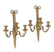 A set of four gilt metal three light wall appliques in Louis XVI style