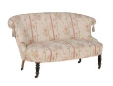 A French ebonised and upholstered sofa