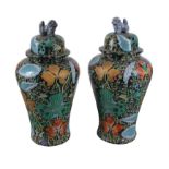 A pair of modern Asian famille noire style baluster floor vases and covers